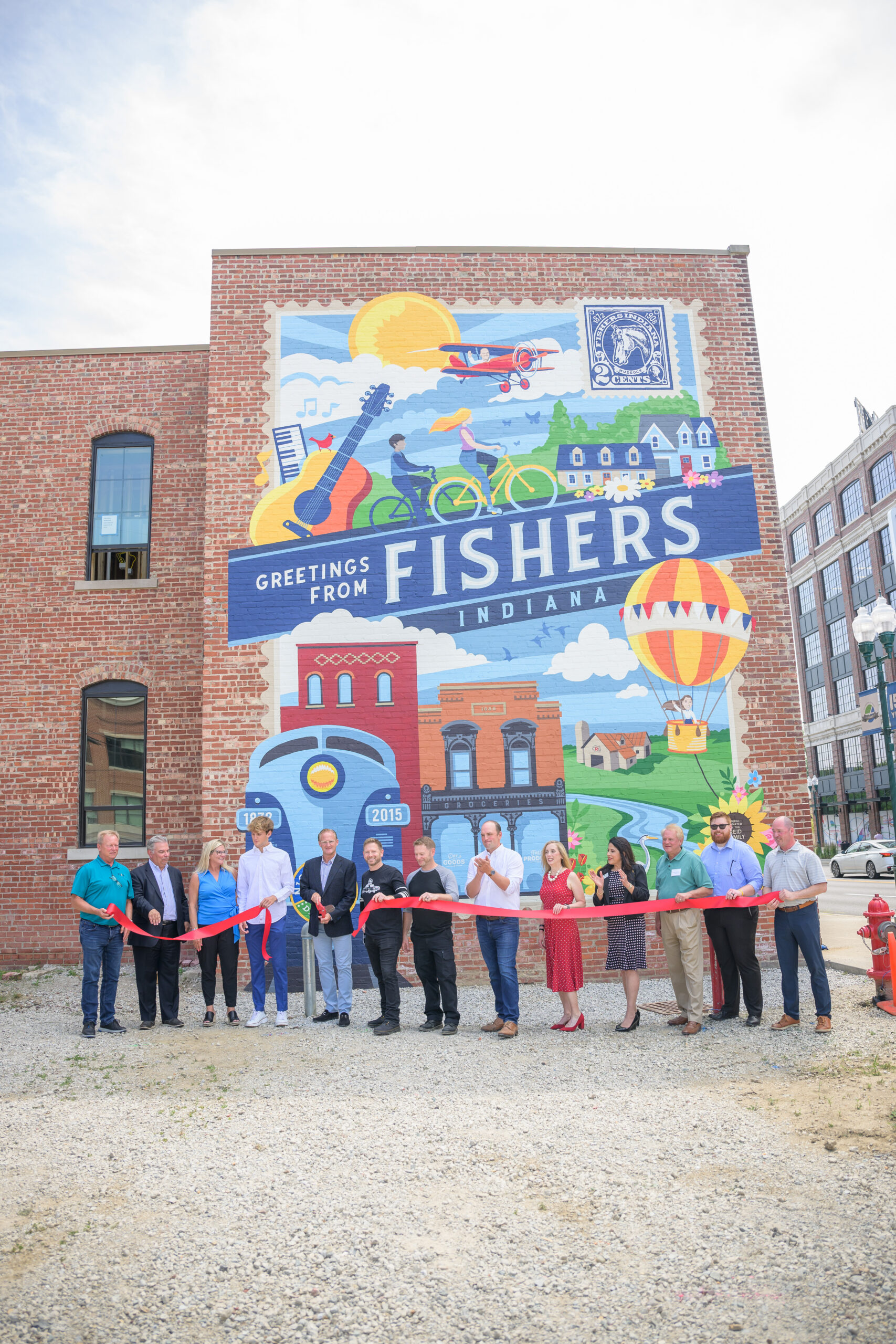 Chris Reid family, City of Fishers Officials celebrate ribbon cutting of Legacy Mural